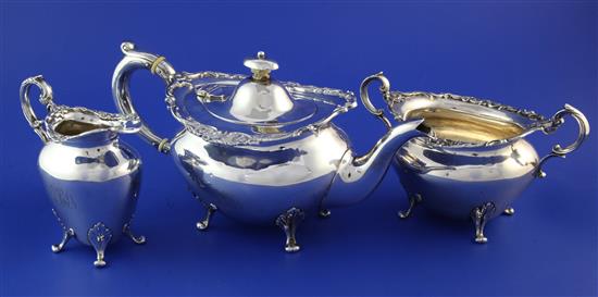 An Edwardian Scottish silver three piece tea set, gross 24.5 oz.